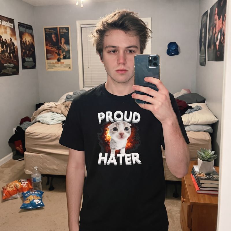 A bedroom mirror selfie in the proud hater tee.